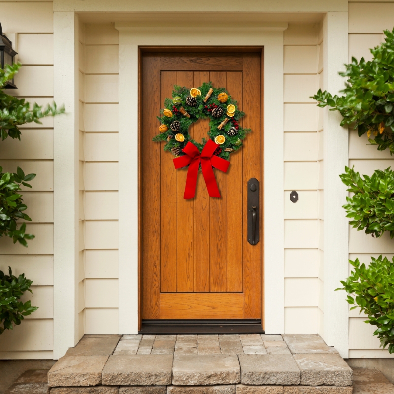 Traditional fresh foliage door wreath with pinecones, cinnamon and fruit slices all finished with a luxury red velvet bow. 