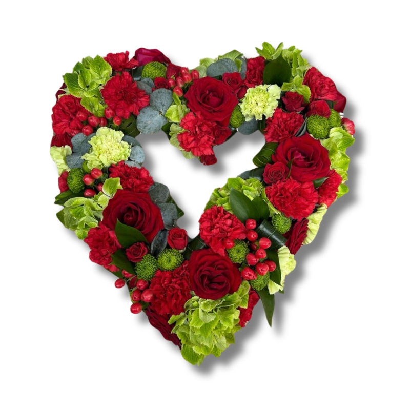 A beautiful red and green mixed open heart funeral tribute filled with seasonal florals. 