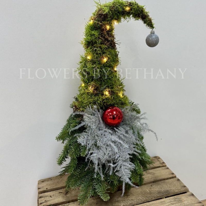 Gordon the gonk is handmade with fresh spruce and moss and adorned with a silver sparkly fern beard, red bauble nose and battery-operated lights, standing at 60cm x 25cm.