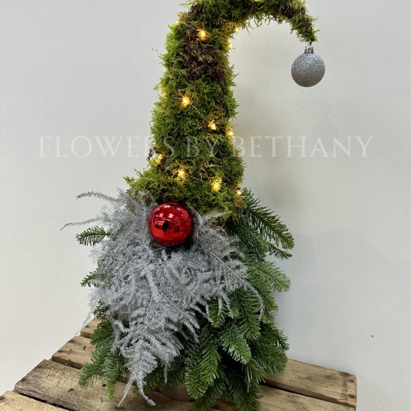 Gordon the gonk is handmade with fresh spruce and moss and adorned with a silver sparkly fern beard, red bauble nose and battery-operated lights, standing at 60cm x 25cm.