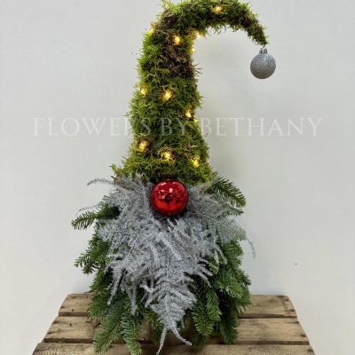 Gordon the gonk is handmade with fresh spruce and moss and adorned with a silver sparkly fern beard, red bauble nose and battery-operated lights, standing at 60cm x 25cm.