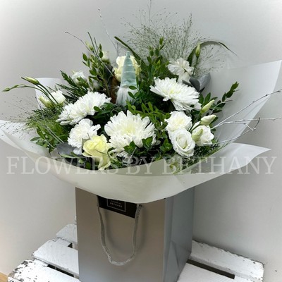 Mixed white bouquet bursting with roses, blooms, carnations and lizianthus to name a few. Hand tied in water and presented in cellophane wrap and our signature gift bag. 