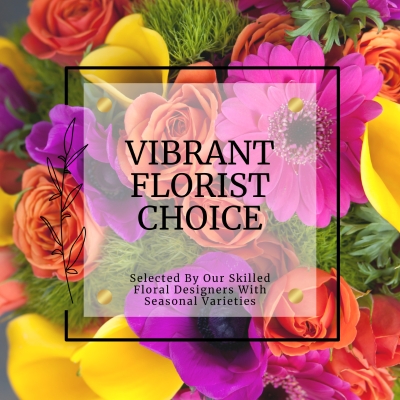 Vibrant florist choice bouquet with seasonal flowers in a bright, cheerful palette, hand-tied in a signature gift bag with water.