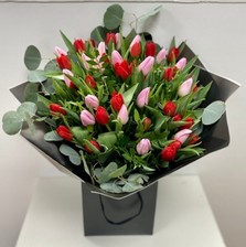 Stunning bomb of pink and red English grown tulips. Finished with eucalyptus collar. 