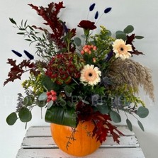 Medium orange pumpkin with floral arrangement including oak leaf, eucalyptus, germini, berries & other seasonal verities. 