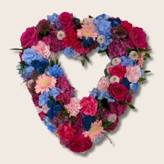 Pink & Blue sapphire toned floral heart funeral tribute including roses, hydrangea and other mixed seasonal florals. 